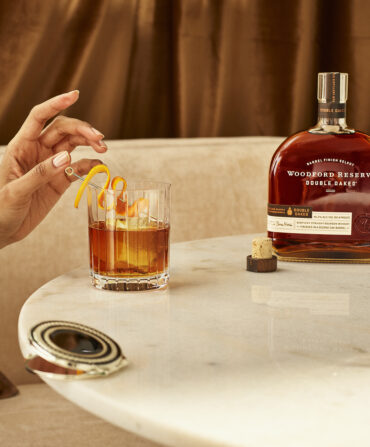 A person drinks an old fashioned cocktail