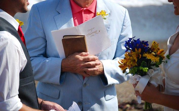 a closeup of a minister presiding over a marriage