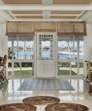 A layered decorated entryway looks to the water