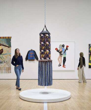 a woman looking at an installation