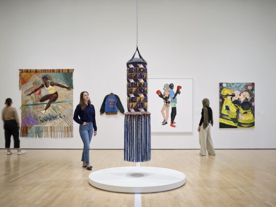 a woman looking at an installation