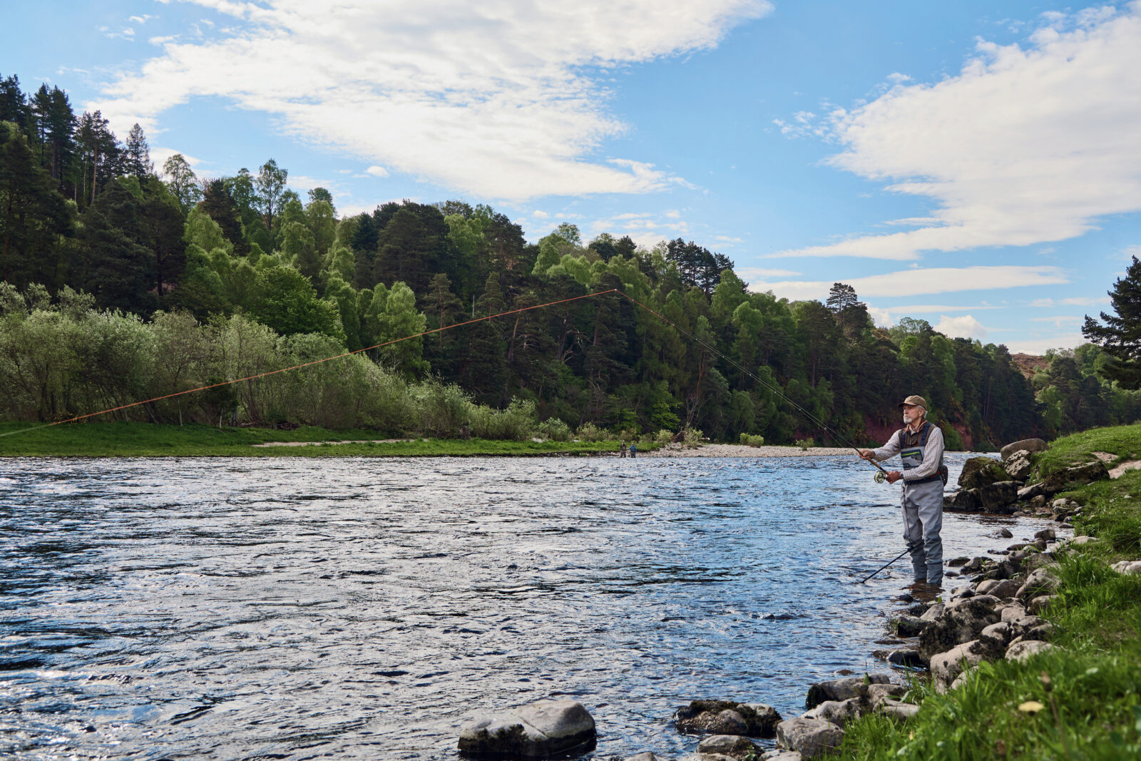 A man fishes in a river