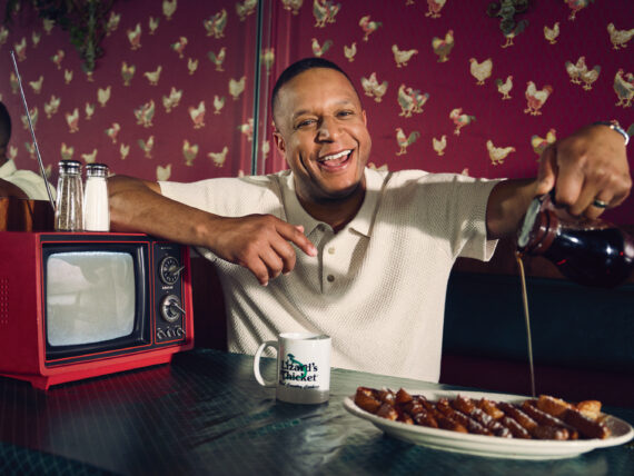 Craig Melvin pours syrup over french toast in a restaurant