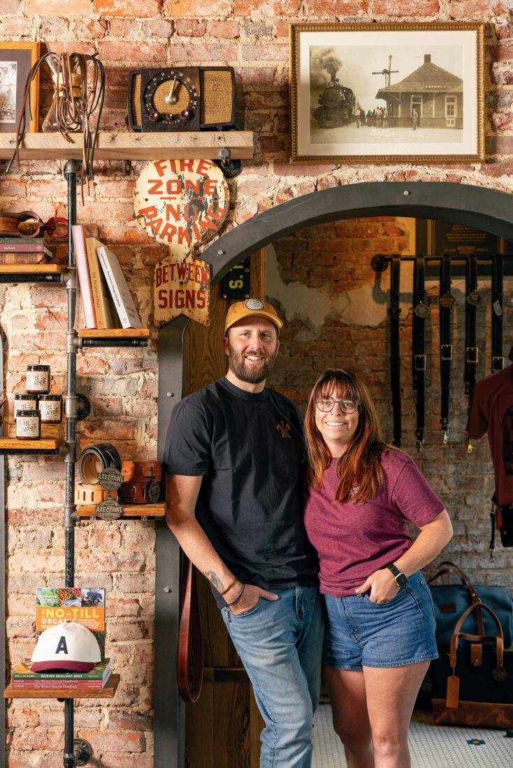 A couple stands in a leather shop