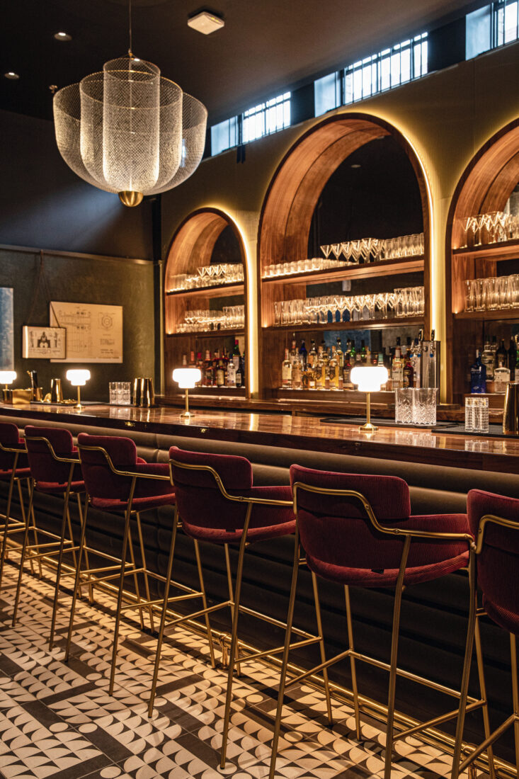 Inside a bar with a curved inlay in the wall and tile floors