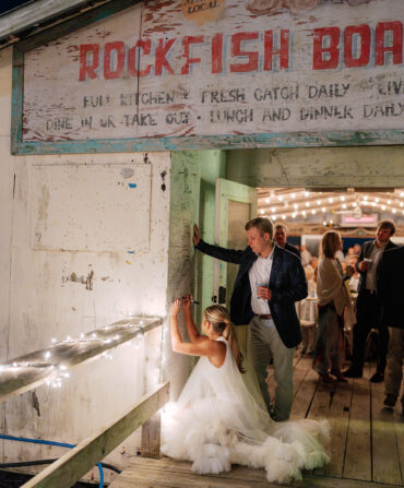 a bride and groom sign a wall