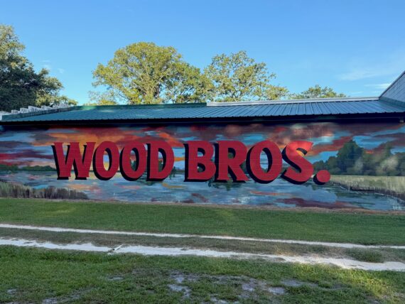 A painted side of a wood building that says "Wood Bros"