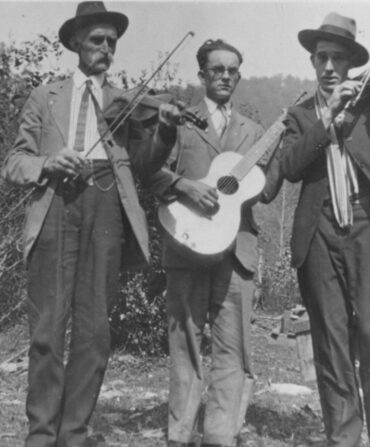 A group of musicians stand outside