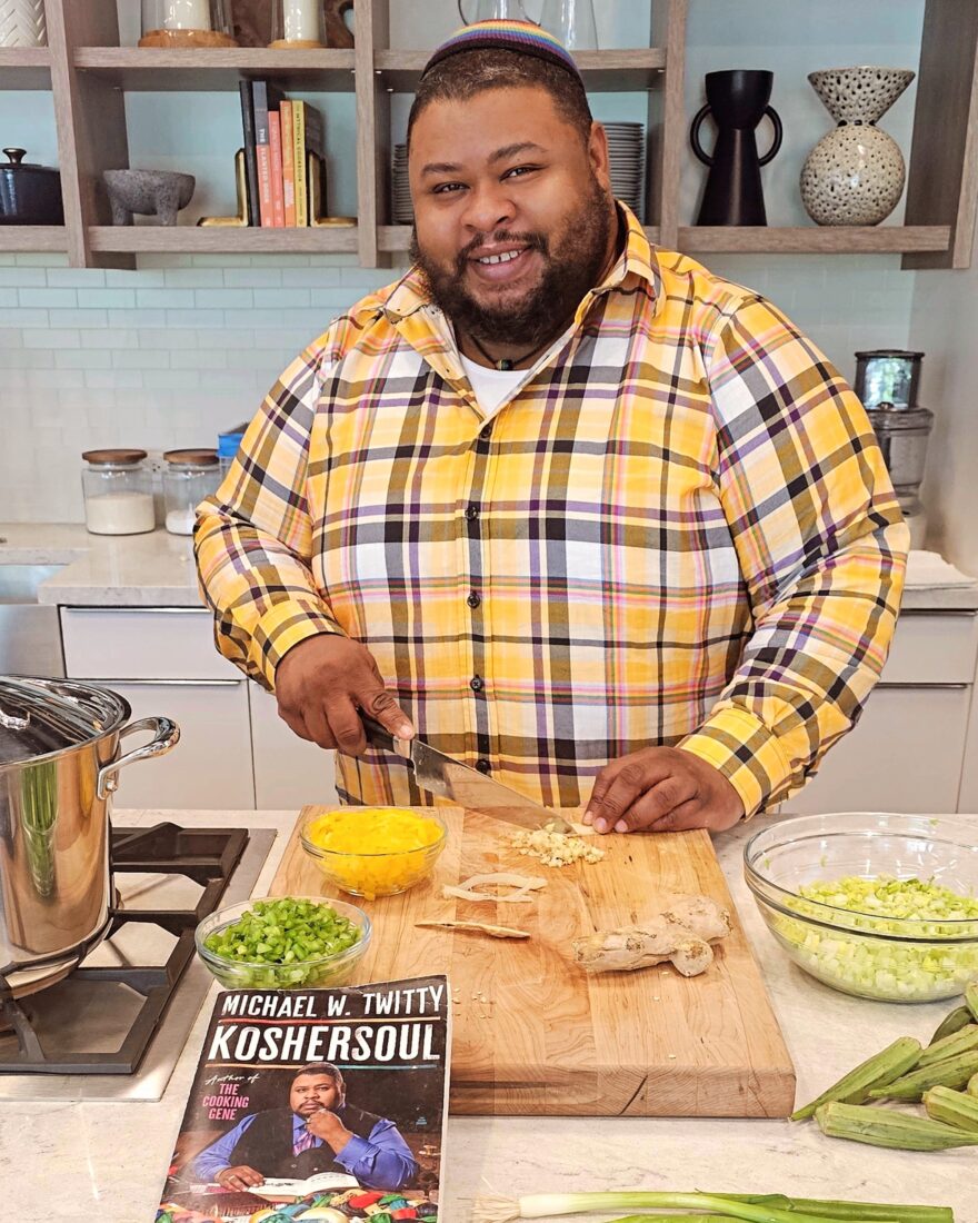 A portrait of a chef in a kitchen at a cutting board