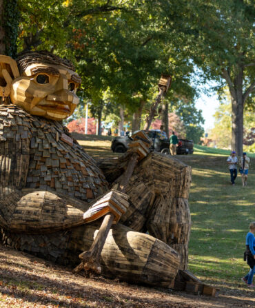 A large troll sculpture in a park