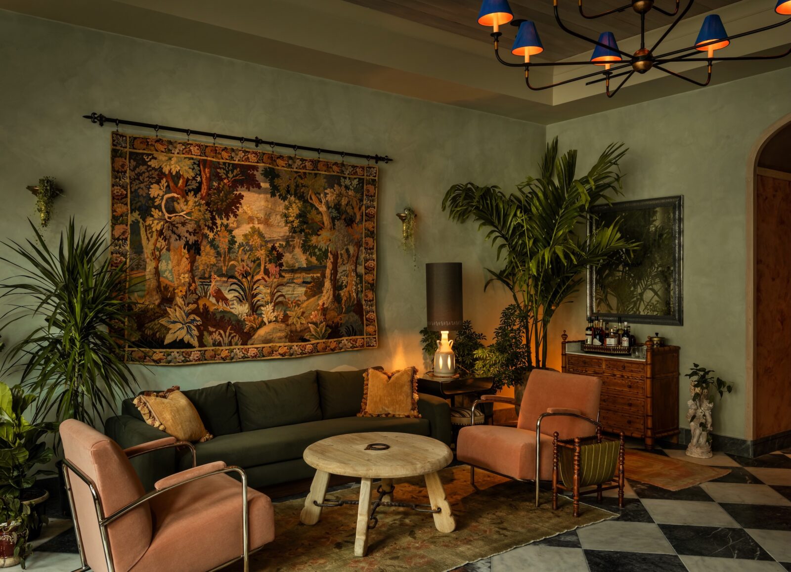 A green lobby entrance with a woodland tapestry on the wall