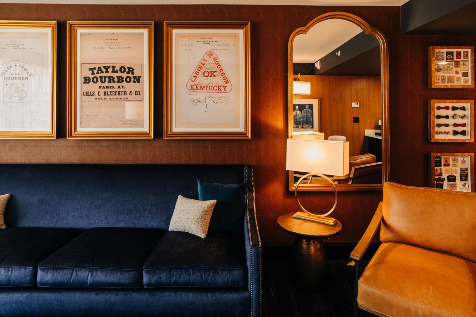Framed vintage bourbon flyers in a hotel room